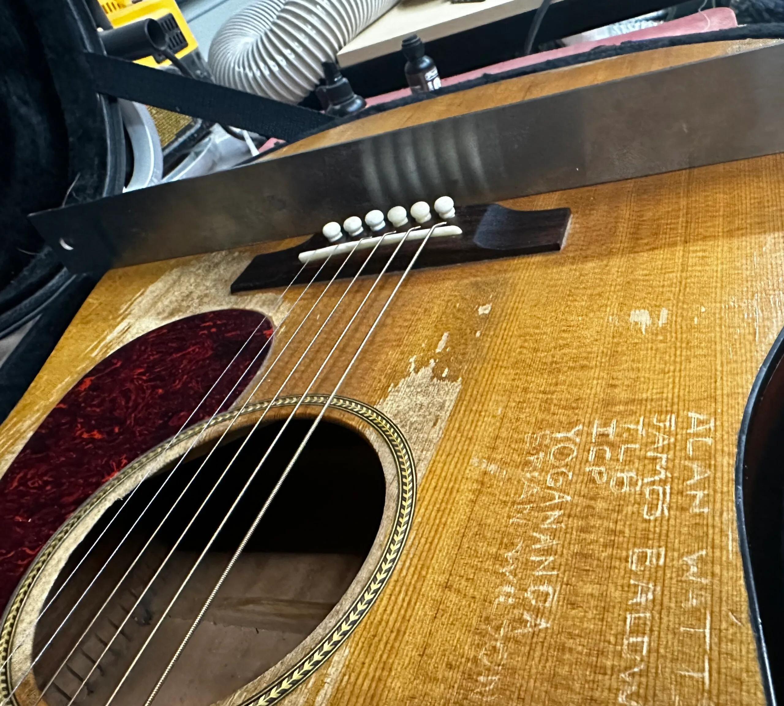 Acoustic guitar showing its been repaired by Fayland Guitars